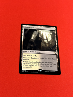 Shadowy Backstreet (MKM #268) Plains Swamp surveil land, Regular Non-Foil MTG LP - Image 1