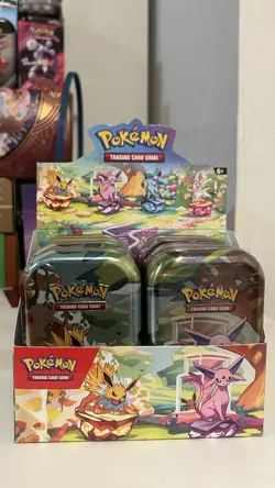 Pokemon TCG Prismatic Evolutions Set Of 8 Sealed Mini Tins W Open Display Box - Image 1