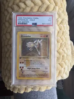 PSA 7 Hitmonlee Fossil 1st Edition 7/62 Cigar Stain Error Holo Pokemon Card NM - Image 1