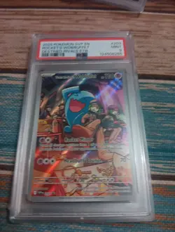 2025 POKEMON DESTINED RIVALS ETB PROMO #203 TEAM ROCKET'S WOBBUFFET PSA 9 - Image 1
