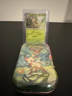 Pokemon Costco Prismatic Evolutions TCG Mini Tin Sealed + Leafeon Foil Card - Image 1
