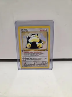 Pokemon Snorlax 27/64 Base Set 1st Edition w/ Top Loader - Image 1