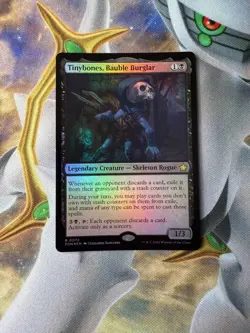 mtg borderless foil Tinybones Bauble Burglar, Foundations NM - Image 1