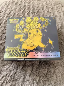 Surging Sparks Pokemon Center Exclusive ETB + 4 Sealed Packs Of Evolving Skies - Image 1