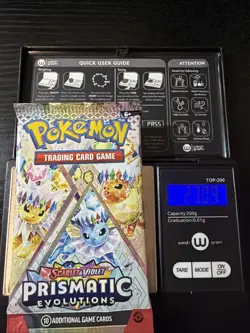 Pokemon TCG Prismatic Evolutions Heavy Booster Pack 23.09g - Image 1
