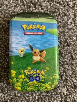 Pokemon collectible tin with miscellaneous cards - Image 1