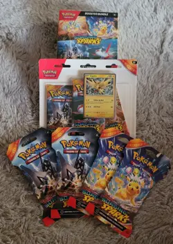Pokemon Surging Sparks Booster Bundle, 3 Pack Blister, And 4 Sleeved Packs! - Image 1