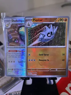 Pokemon TCG Pupitar and Dudunsparce Poke Ball Pattern Prismatic Evolutions - Image 1