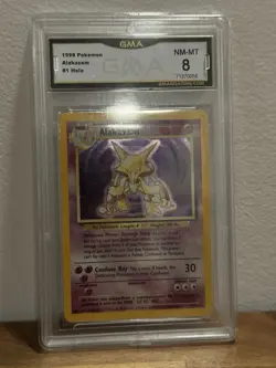 ALAKAZAM 1999 POKEMON BASE SET #1 GMA 8 NM-MT REGRADEU - Image 1