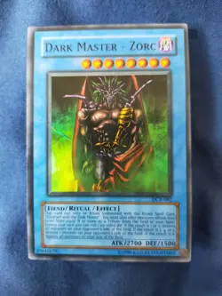 Used Dark Master - Zorc (DCR) super rare Yugioh card (creased) - Image 1