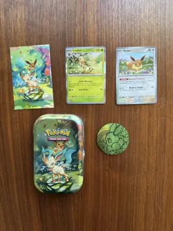 Prismatic Evolutions Leafeon tin + NM Holos & Promo Card & Coin - Image 1