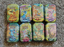 Pokemon TCG Prismatic Evolutions Mini Tin Complete Set - 8 Factory Sealed Tins - Image 1