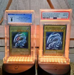 2002 Yu-gi-oh CGC 8 Mint Blue Eyes White Dragon SDK001 & PSA 8 Japanese Sealed - Image 1
