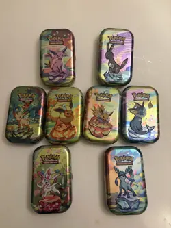 BRAND NEW Pokemon Prismatic Evolutions | Empty Mini Tins With Coins And Art Card - Image 1