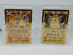 Pokemon Celebrations Gold Metal Charizard & Pikachu cards in original packaging - Image 1
