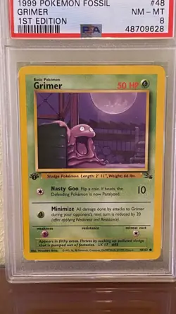 1999 Pokemon Fossil #48 Grimer 1st Edition PSA 8 NM-MT - Image 1