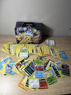 Pokemon Cards In A Pokemon TCG Surging Sparks Collector's Lunch Box Tin - Image 1