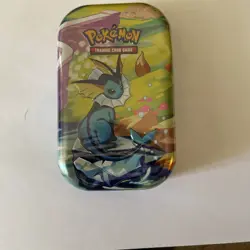 Pokemon TCG Prismatic Evolutions Sealed Mini Tin Vaporeon Sealed *Dented* - Image 1