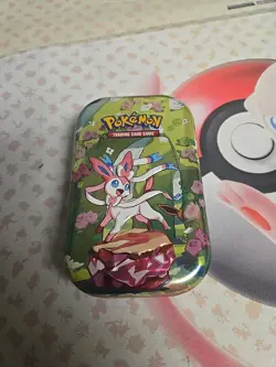 *EMPTY NO PACKS* Pokemon Prismatic Mini Tin Includes Art Card & Coin. Sylveon - Image 1