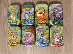 Prismatic Evolutions *EMPTY* Mini Tin Complete Set Of 8 (Tin + Card + Coin) - Image 1