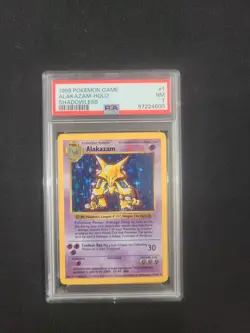 1999 POKEMON GAME BASE SET #1 ALAKAZAM HOLO SHADOWLESS PSA 7 NM CARD - Image 1