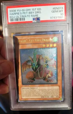 PSA 10 - YUGIOH - 2006 - EOJ-EN013 - HARPIE'S PET BABY DRAGON - ULTIMATE RARE - Image 1