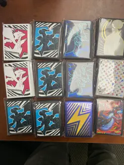 Lot of 12 Assorted Pokemon Sealed ETB Card Sleeves With Tin - Image 1