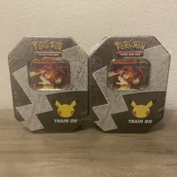 Two (2) New and Sealed Pokemon 25th Celebrations Lance's Charizard V Tin - Image 1