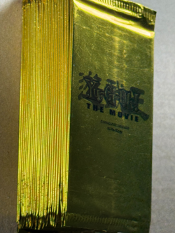 28 factory-sealed Yu-Gi-Oh! The Movie gold promo packs from 2004 - Image 1
