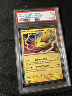 2025 POKEMON DESTINED RIVALS #070 TEAM ROCKET'S ZAPDOS GAMESTOP EXCLUSIVE PSA 7 - Image 1