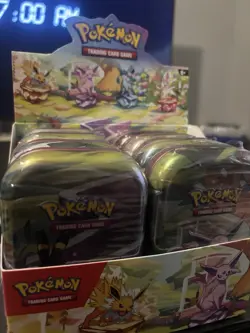 Pokemon TCG Prismatic Evolutions Full Set of 8 Sealed Mini Tins With Display - Image 1