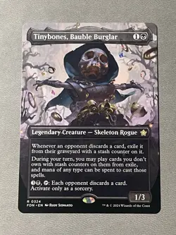 MTG Tinybones, Bauble Burglar Borderless Foundations #324 Near Mint NM - Image 1