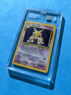 Pokemon TCG Alakazam Holo Card Base Set 1/102 TAG 8 near Mint - Image 1