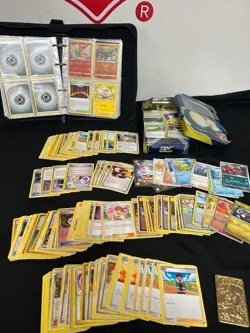 Lot of Previously Owned Pokemon Cards Includes A GX Tag Team Tin and Binder - Image 1