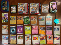 POKEMON PRISMATIC EVOLUTIONS TIN, COIN, WRAPPERS, CARDS, CODES & STICKER - Image 1