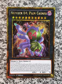 Yugioh Number 84: Pain Gainer PGL3-EN010 Gold Secret Rare 1st Edition NM 2016 - Image 1