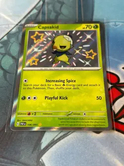 Pokemon Capsakid 106/091 Paldean Fates Holo Rare Baby Shiny Pokemon Card NM - Image 1