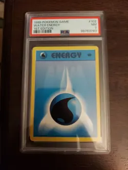 1999 Pokemon GAME 1st Edition Water Energy #102 PSA 7 - Image 1
