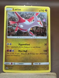 Latias SM135 Sun & Moon Black Star Promo Cosmos Holo Pokemon Card Partial Swirl - Image 1