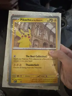 Pokemon x Natural History Museum Pikachu Jumbo Promo Card in hand - Image 1