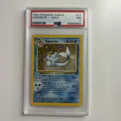 VAPOREON 12/64 HOLO NO SYMBOL ERROR POKEMON - 1999 WOTC Jungle - PSA 7 MINT - Image 1
