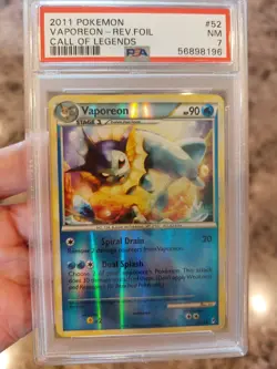PSA 7 NM 2011 POKEMON CALL OF LEGENDS SET VAPOREON REVERSE HOLO CARD 52/95 - Image 1