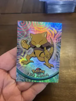 1999 Topps Pokemon TV Animation #63 Abra Rainbow Foil Black Logo - Image 1