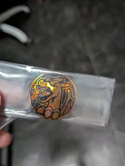 Official Mini Charizard Cracked Ice Dark Orange Pokemon TCG Coin - Image 1