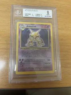 1999 WOTC Pokemon Base Set Alakazam 1/102 Unlimited Holo TCG CGC 8.5 NM/MINT+ - Image 1
