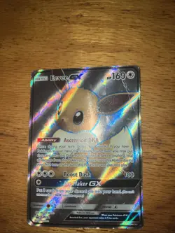 Pokemon TCG Eevee GX SM242 Full Art Holo Card with Sleeve, And Card Case - Image 1
