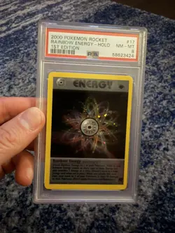 PSA 8 NM/MINT Rainbow Energy 17/82 1ST EDITION Team Rocket HOLO Pokemon Card - Image 1