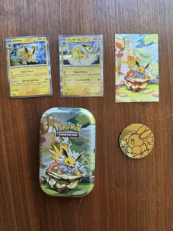 Prismatic Evolutions Jolteon tin + NM Holos & Promo Card & Coin - Image 1