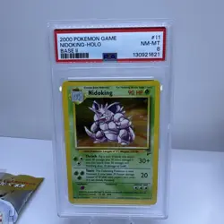 1999 POKEMON BASE SET UNLIMITED #11 NIDOKING-HOLO PSA 8 - Image 1