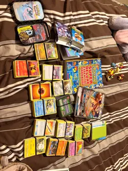 Box of pokemon cards, pokemon toys, a pokedex, game mats, all from my childhood. - Image 1